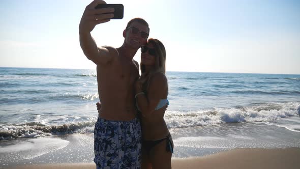 Young Smiling Couple Taking Self Photo at Seascape Background. Happy Traveling Pair Making