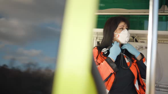Sad Young Female Paramedic Puts on Stethoscope and Feels Down alt