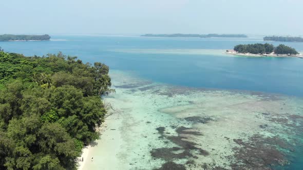 Cinematic aerial view of island in the beautiful blue ocean.