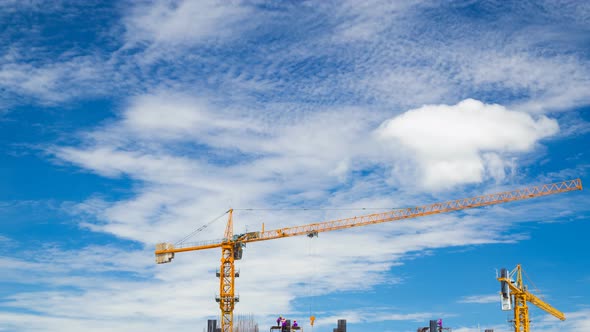 4k Time-lapse of construction crane and worker of building industry with blue sky
