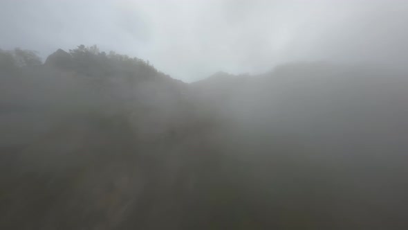 Drone Shot Flying Through the Cloud Up to the Top of Gorge
