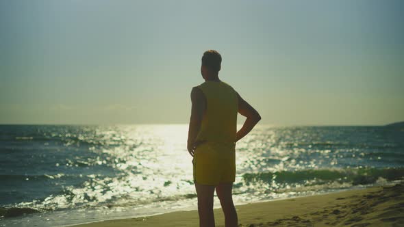 Runner standing with hands on hips