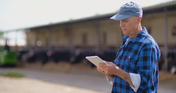Farmer using digital tablet  alt