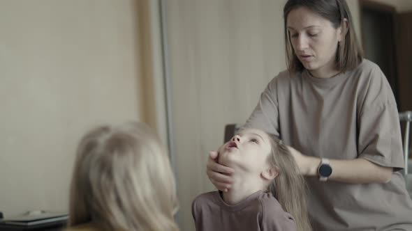 Mom Braids Daughters at Home