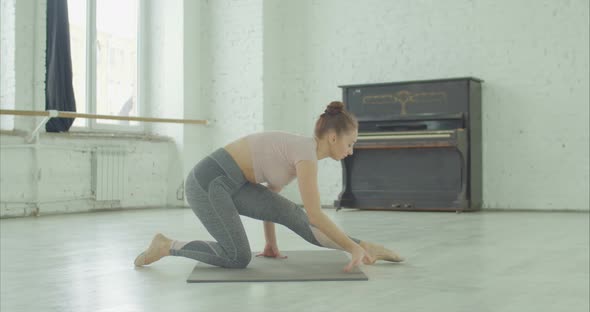 Beautiful Ballet Dancer Stretching Out Muscles alt