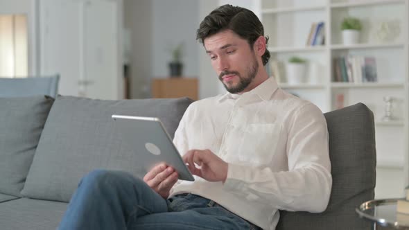 Man Using Tablet at Home alt