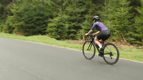 Cycling. Cyclist on bicycle. Woman rides bike in mountains alt