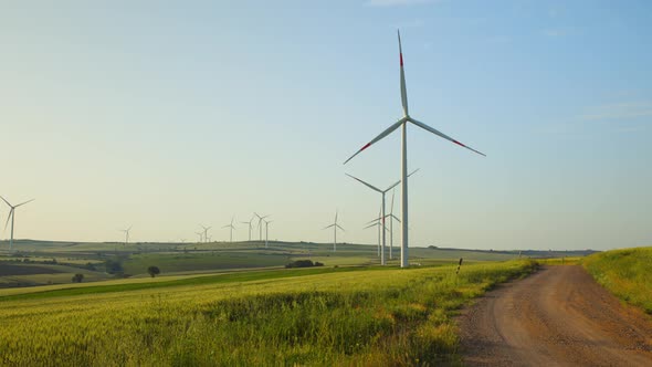 Windmill farm in the field. Alternative green energy concept alt