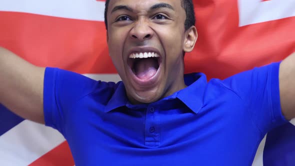British Fan Celebrates Holding the British Flag alt