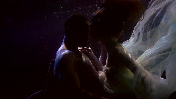 Tender Caress of Young Lovers Underwater, Black Man and White Woman Are Floating Together alt