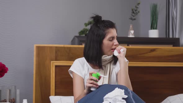woman coughting cold,coughing and taking a cure with throat sprey during angina disease alt
