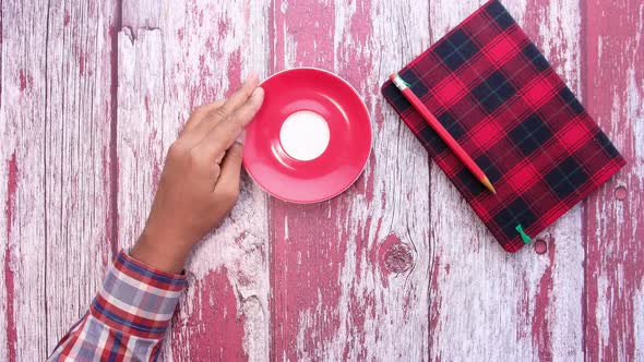 Top View of Man Hand Drinking Green Tea. alt