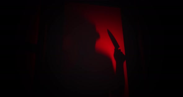 Spooky killer shadow with a knife