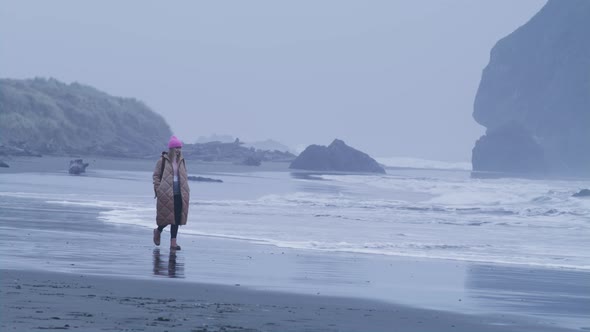 Slow Motion RED Camera Shot of Alone Attractive Woman Walking Oregon Coat Beach alt
