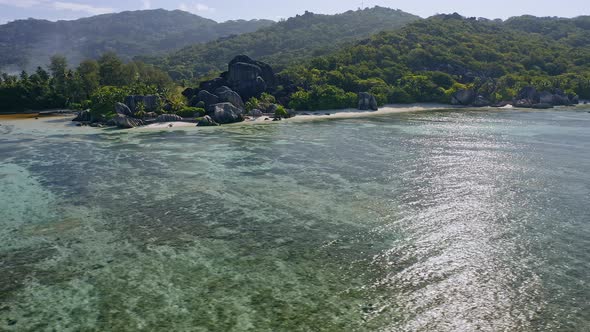 Aerial Footage Circling Around Granite Boulders on Famous Anse Source d'Argent Tropical Beach