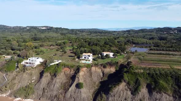 Spectacular aerial drone flight fly forwards drone shot on a sunny day time of a house with pool on alt