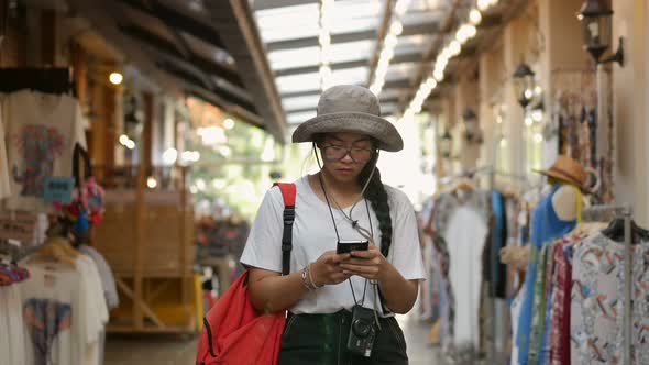 Young Asian woman hand using smartphone at the market.