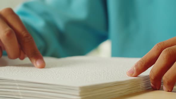 African American Man Reading Braille Book Closeup alt