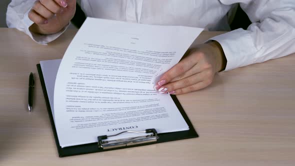 Young Business Woman Read and Signing Contract