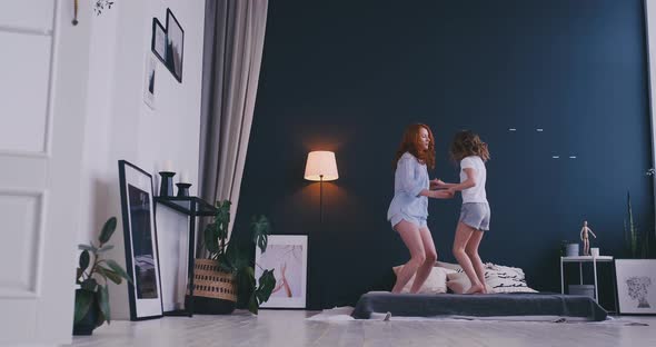 Mother and Daughter Jumping on the Bed, Happiness, Joyful alt