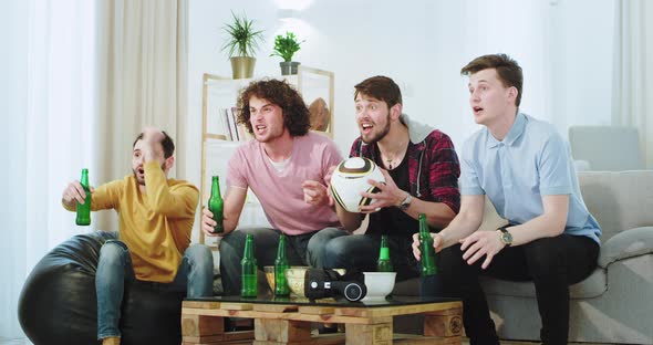 Big Company of Men Watching a Football Match They alt