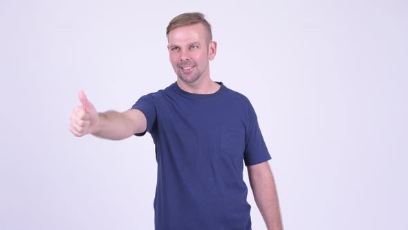 Portrait of Happy Blonde Man Giving Thumbs Up alt