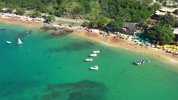 Arial shot over the colorful green waters of Buzios bay in Brazil alt