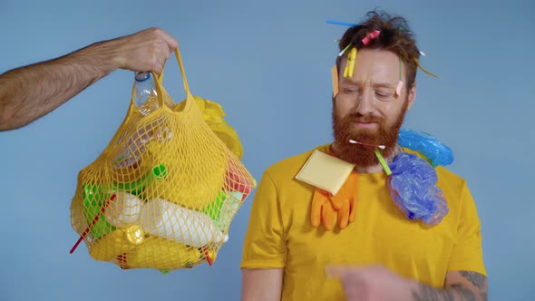 Man looking on the package full of garbage.