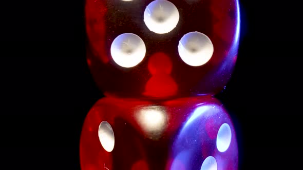 Red Dice Spinning on an Isolated Black Background alt