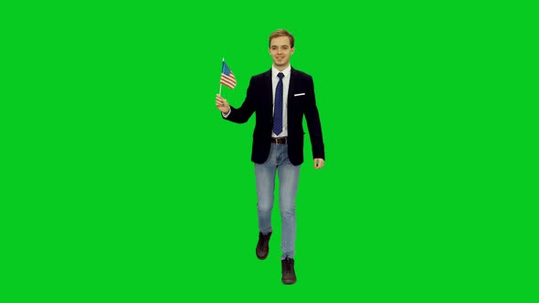 Young Happy Guy Walking with Waving Flag of USA on Green Screen