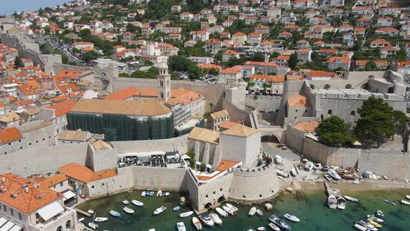 Aerial drone shot of Dubrovnik Cathedral in repair with old port in Croatia sunrise hour. View of th alt
