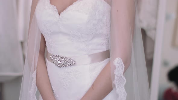 Young bride admiring herself in wedding dress