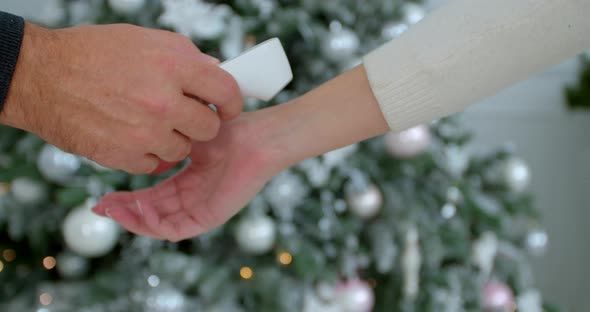 COVID-19 Body Temperature Measuring for Coronavirus. A Woman's Temperature Is Taken for Controlling alt