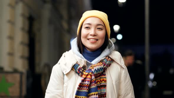 Asian woman walking at the evening street.