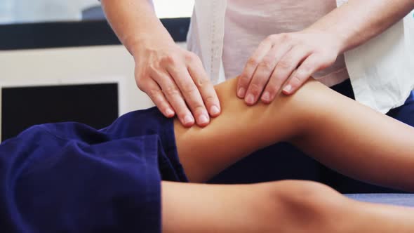 Physiotherapist giving physical therapy to the boy 4k alt