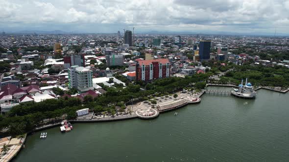 aerial view of Makassar city Sulawesi Indonesia on a sunny day along the water with a mosque in the alt