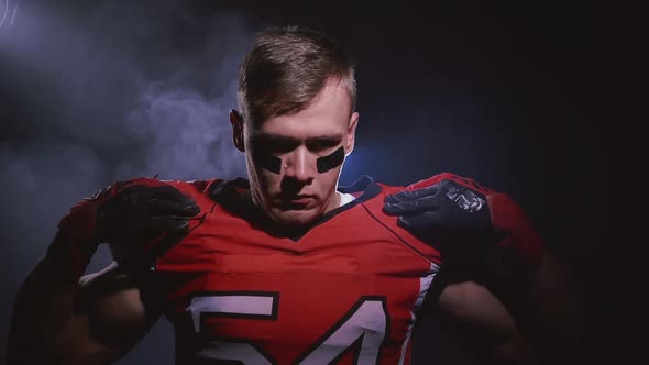 Portrait of Determined Professional American Football Player Warming Up in Bright Stadium alt
