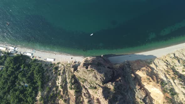 Aerial View From Above on Calm Azure Sea and Volcanic Rocky Shores alt