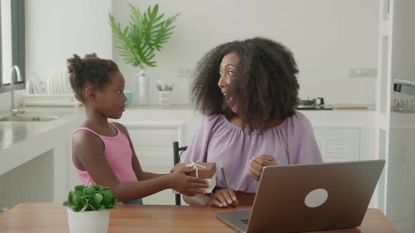 Multitasking Young African Woman Freelance Worker Entrepreneur Working Remotely on Laptop While Her alt