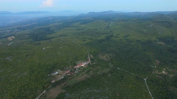 Aerial view of remote village in green peaceful valley alt