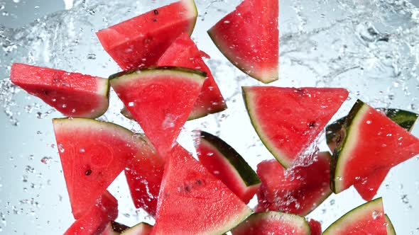 Super Slow Motion Shot of Flying Fresh Melon Cuts and Water Side Splash at 1000 Fps alt