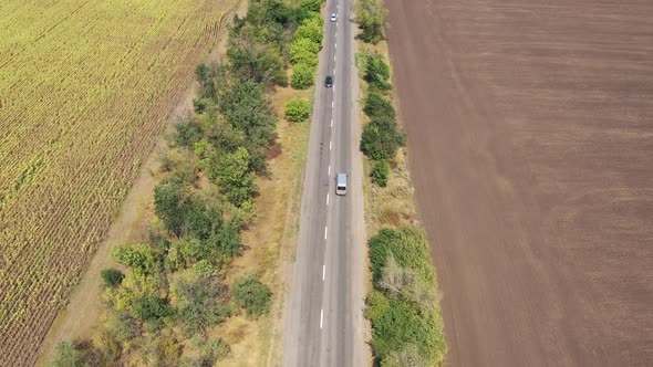 Highway among agricultural fields. Aerial view