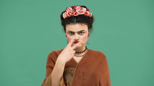 Portrait of Woman with Thick Eyebrows and Red Lips Makeup As Frida Kahlo Wearing Roses in Hair and alt