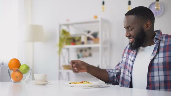 African-American Man Eating Spoiled Spaghetti on Lunch, Stomach Disease, Nausea alt