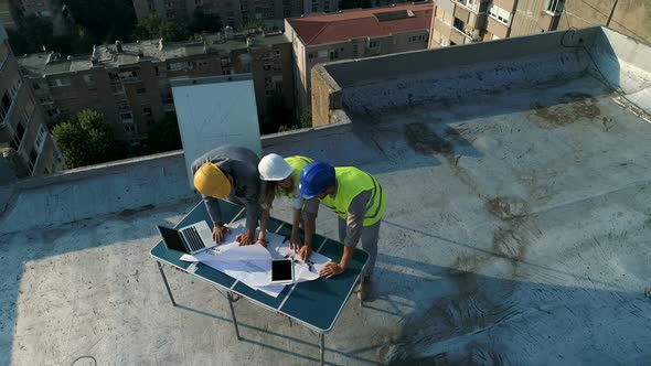 Team of Architects People in Group on Construction Site Check Documents