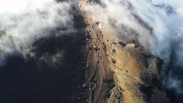 Drone footage of the summit of the Piton des Neiges in the clouds at the Reunion island. alt