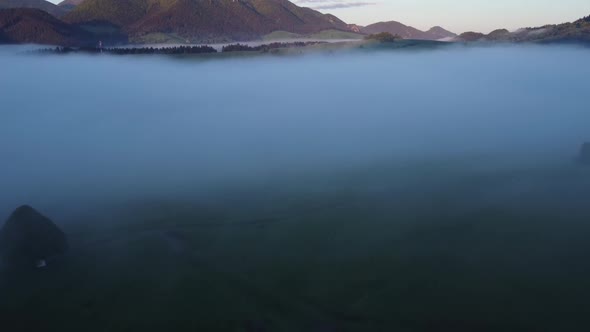 Misty Sea in Spring Green Rural Alpine Landscape at Sunrise