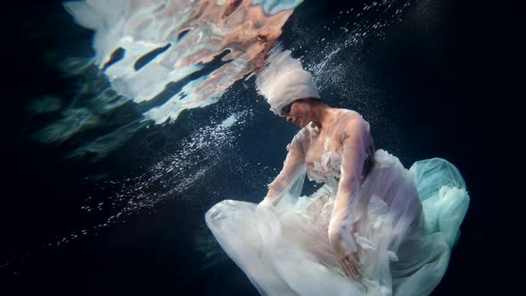Fabulous Underwater Shot with Graceful Lady in Depth Mysterious Deepness alt