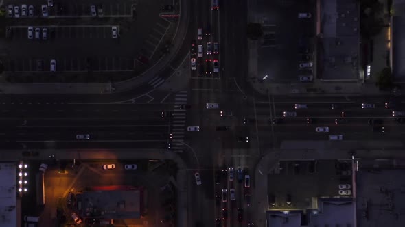 AERIAL: Birds Eye View of Culver City, Los Angeles, California Traffic, Intersection at Dusk with alt