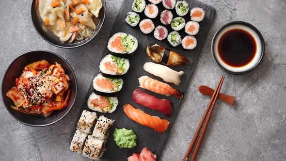 Various Kinds of Sushi Placed on Black Stone Board